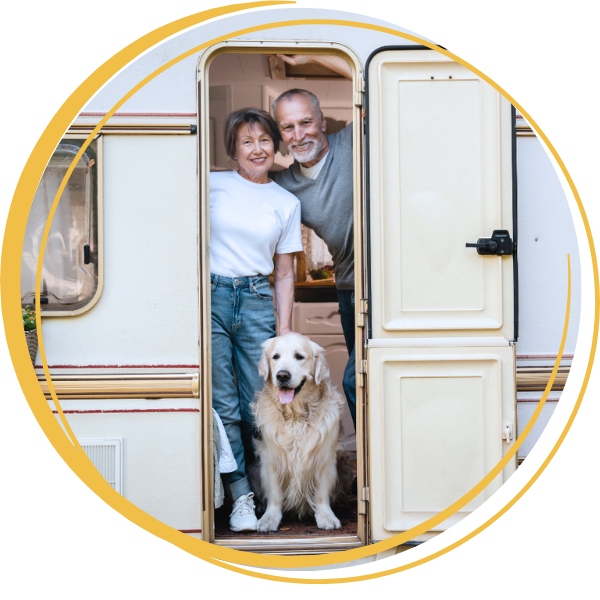 A couple with dog in a camper.