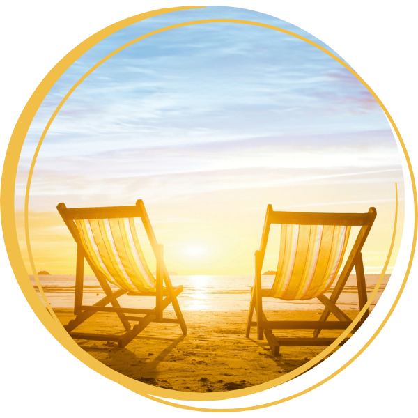 Two chairs on the beach with a sunset
