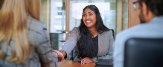 Business woman shaking someone's hand.